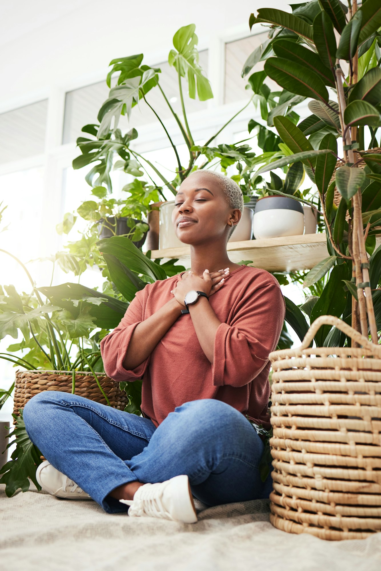 Wellness, peace and woman breathing by plants for meditation in a natural greenhouse. Breathe, grat